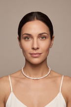 White baroque nugget pearl choker worn on the neck